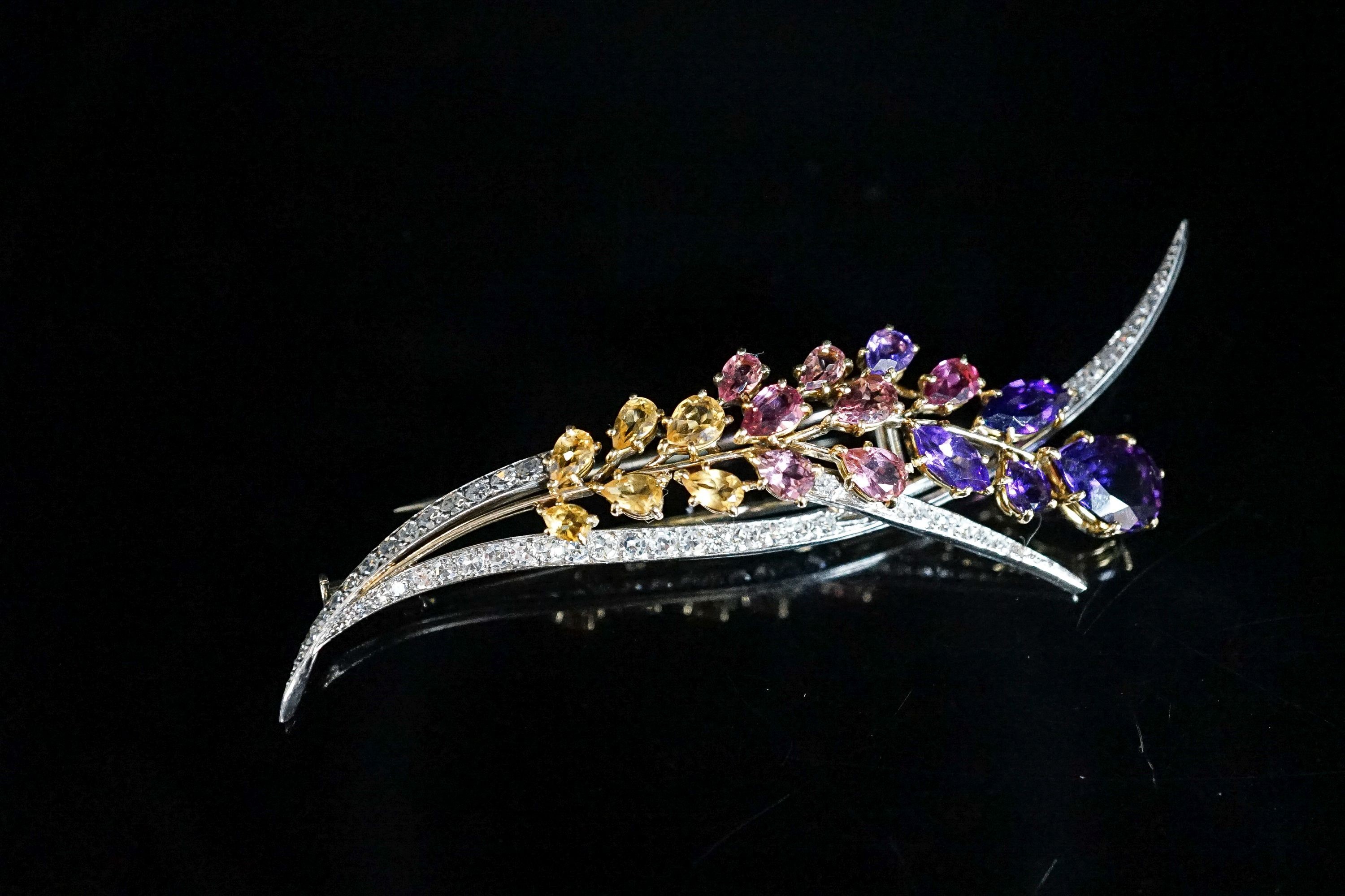 A French 18ct white metal, diamond and multi gem set floral spray brooch, 85mm, gross 17.4 grams.